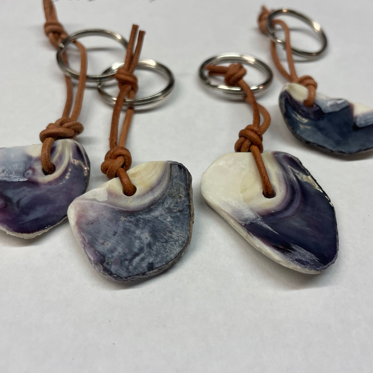 One Keychain Quahog shell Wampum hand made. Shell carvings vary.